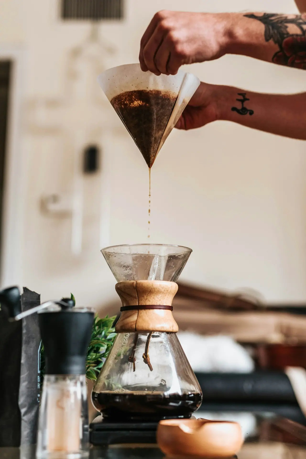 Coffee dripping from a pour-over into a carafe