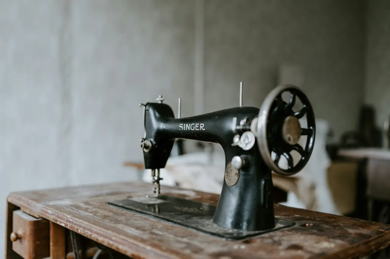 A vintage sewing machine on a wooden table